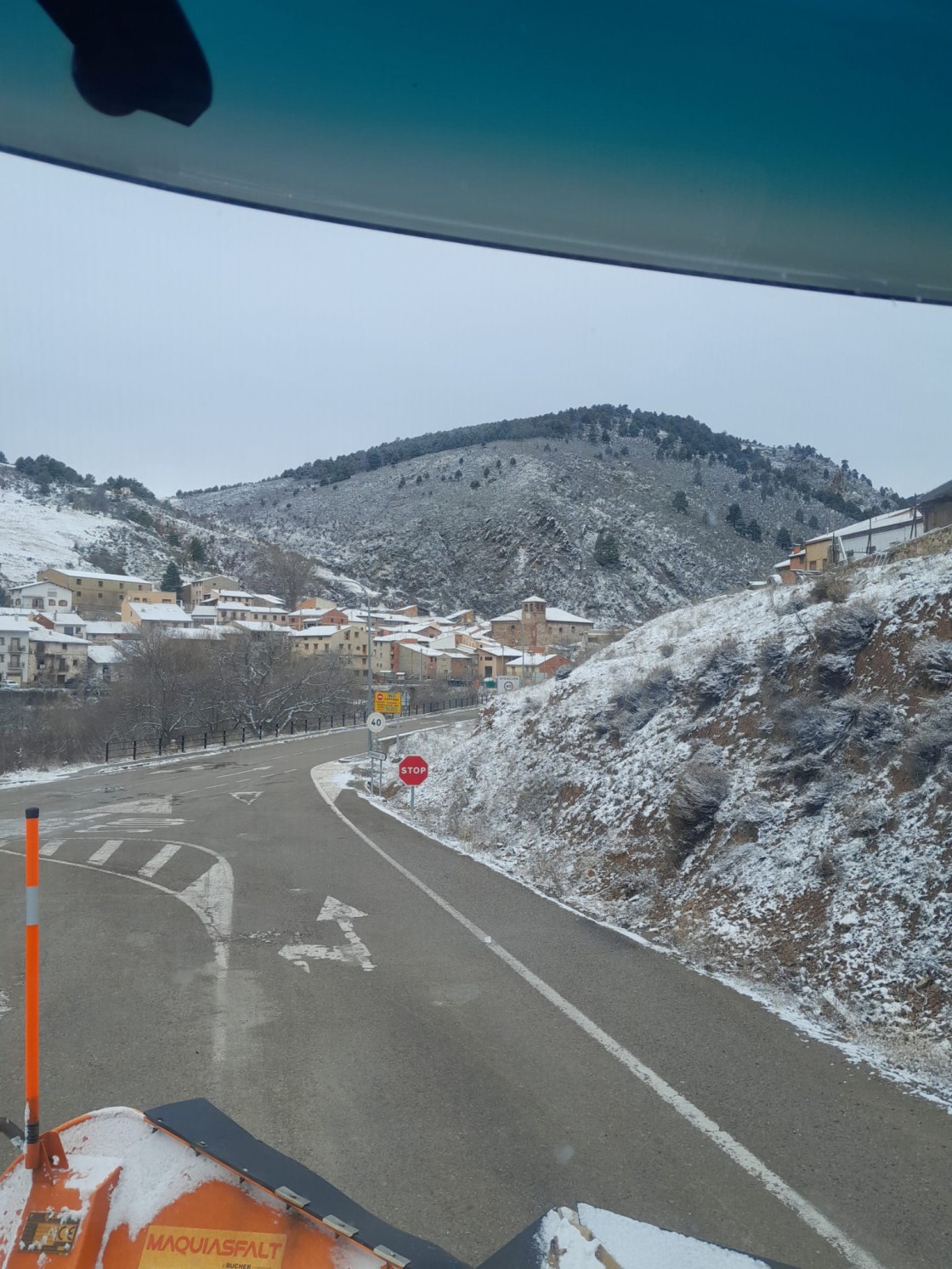 Limpieza de una carretera con Noguera de Albarracín al fondo